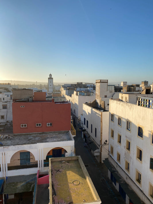 Essaouira rooftops and white buildings at sunrise